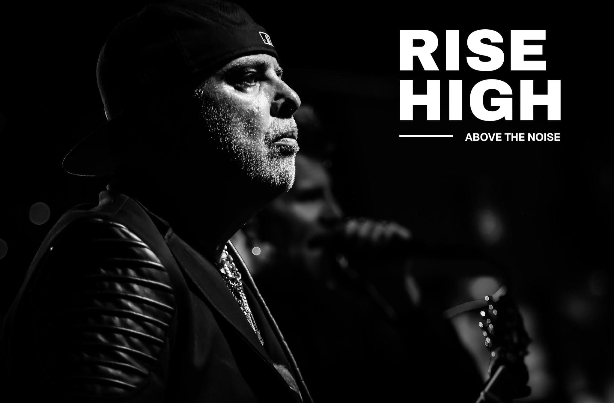 Black-and-white editorial portrait of Alberto González in profile with Rise High Above the Noise typography.